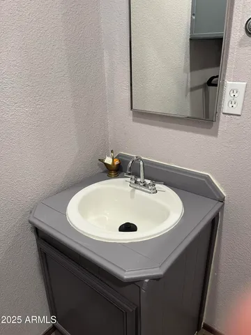 a sink sitting under a bathroom sink