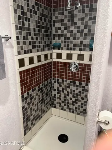 a bathroom with a black white checkered floor