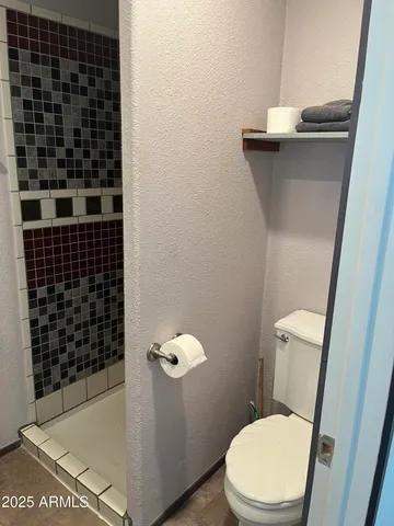 a white toilet sitting next to a bathroom sink