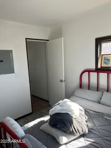 a bedroom with a bed and a mirror