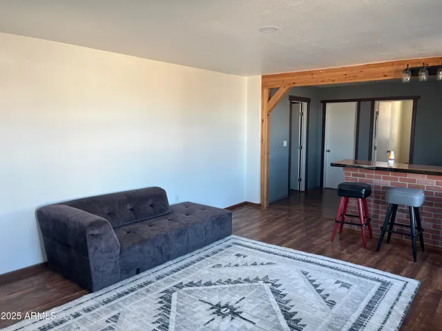 a living room with couches rug and a large window