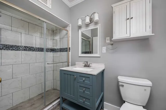 a bathroom with a toilet sink and mirror