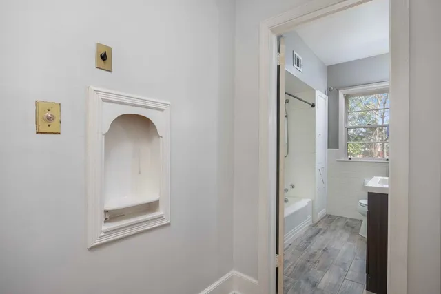 a view of a bathroom with toilet and window