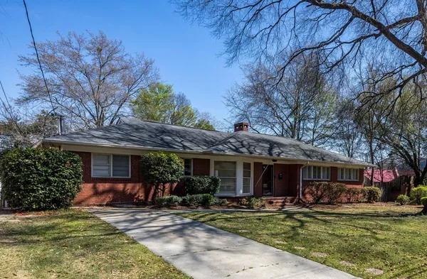 a view of a house with garden and porch