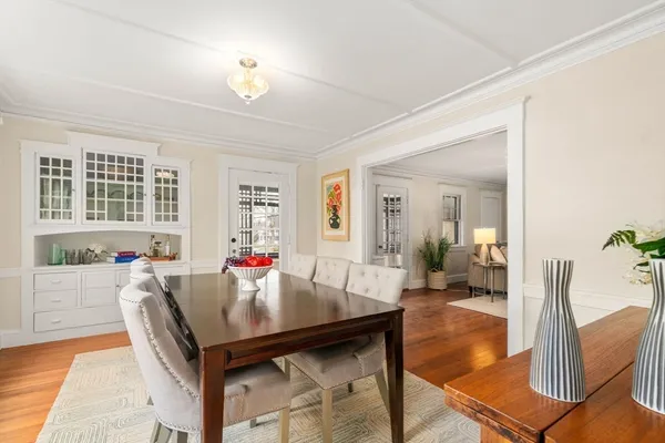 a view of a dining room with furniture and chandelier