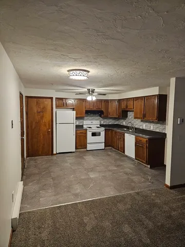 a large kitchen with stainless steel appliances granite countertop a stove and a sink