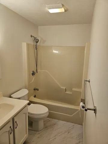 a bathroom with a toilet sink and shower