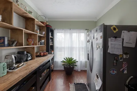 a kitchen with stainless steel appliances a stove a refrigerator and cabinets