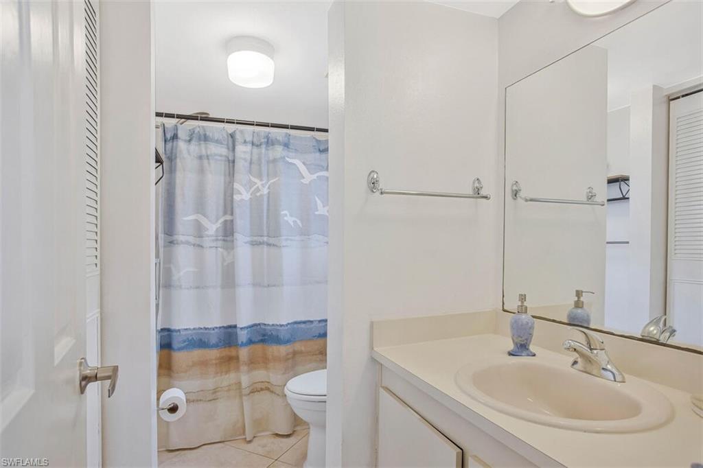 4318 27th Court Southwest, Unit 101 Naples, FL 34116 - Photo 27 of 32 On suite bath with step in shower and large linen closet