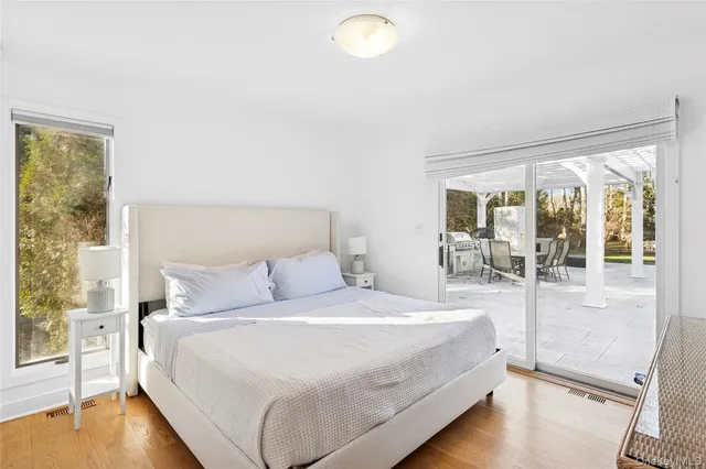 a large bed sitting in a bedroom next to a window