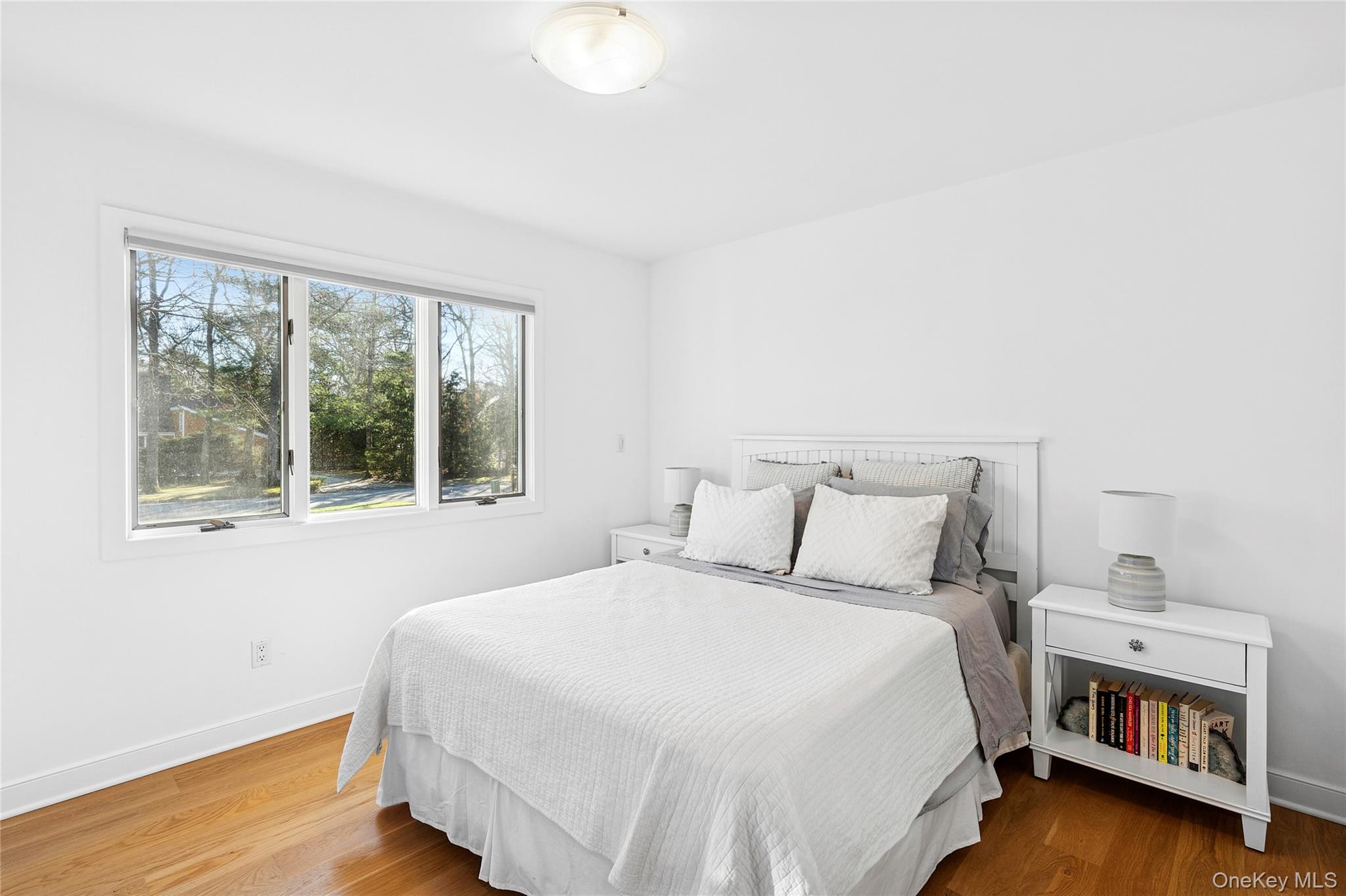 47 Bridle Path Remsenburg, NY 11960 - Photo 13 of 20 a bedroom with a bed and a window