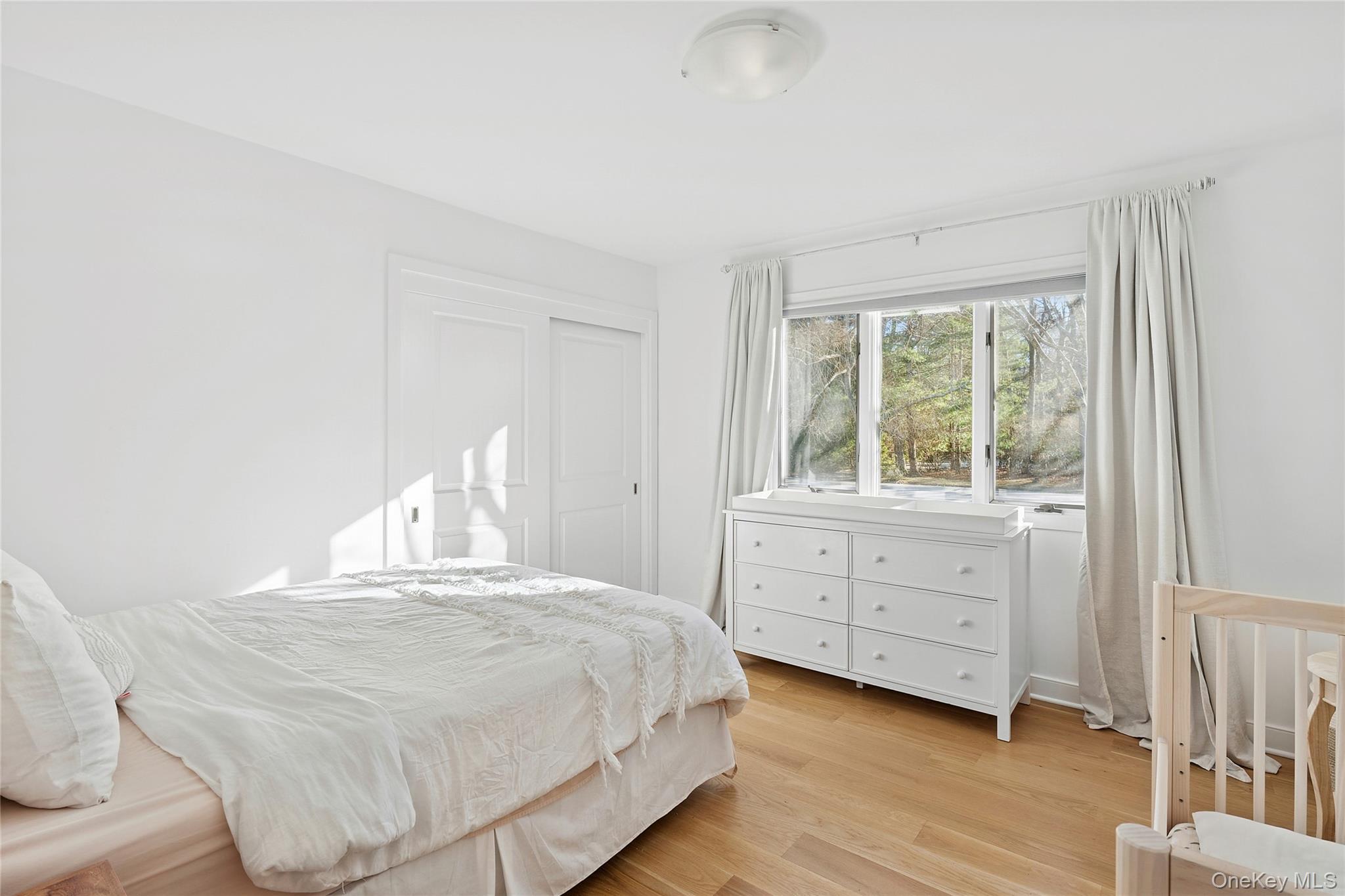 47 Bridle Path Remsenburg, NY 11960 - Photo 14 of 20 a bedroom with a bed and a window