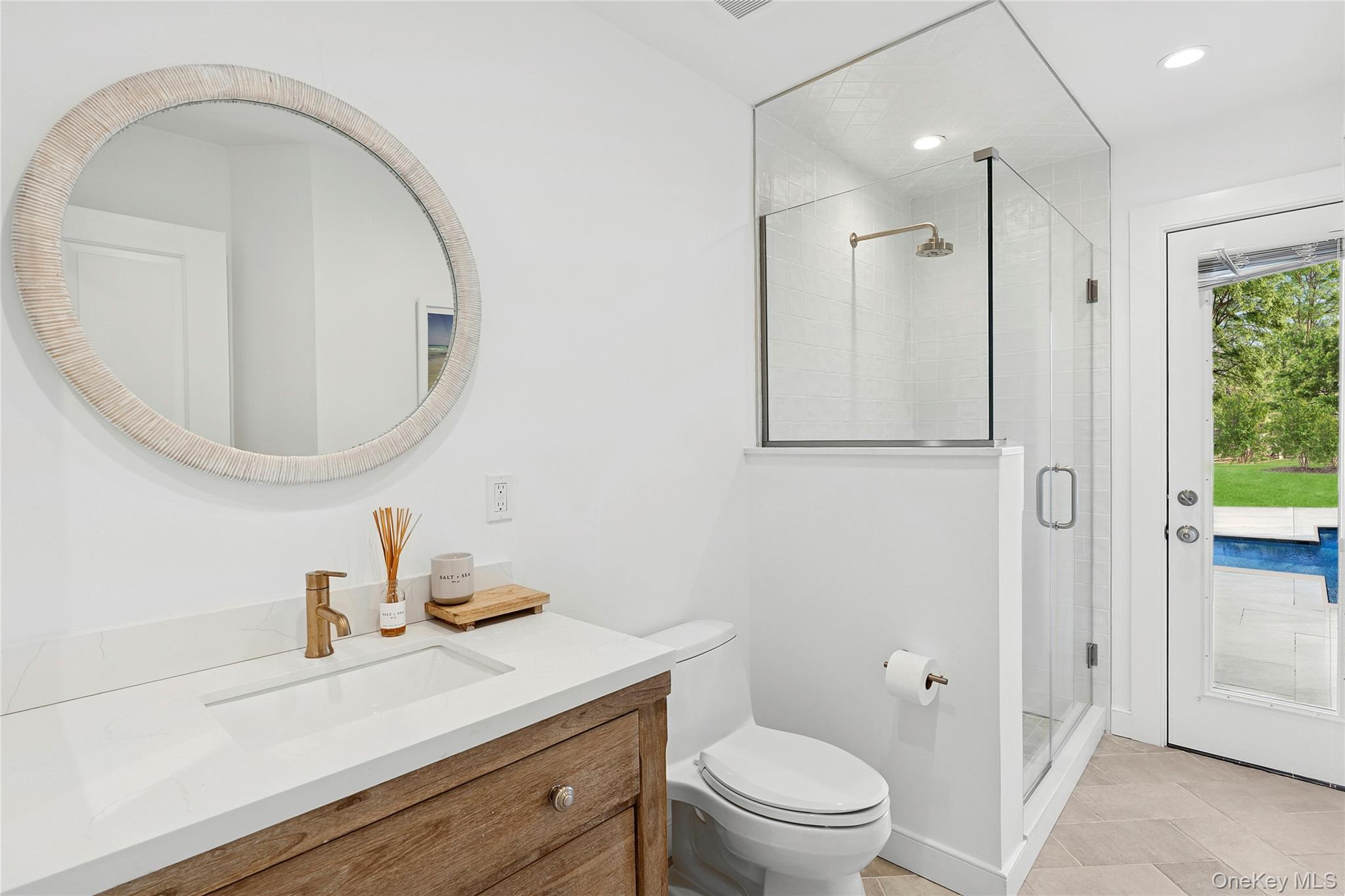47 Bridle Path Remsenburg, NY 11960 - Photo 15 of 20 a bathroom with a sink a toilet and a mirror