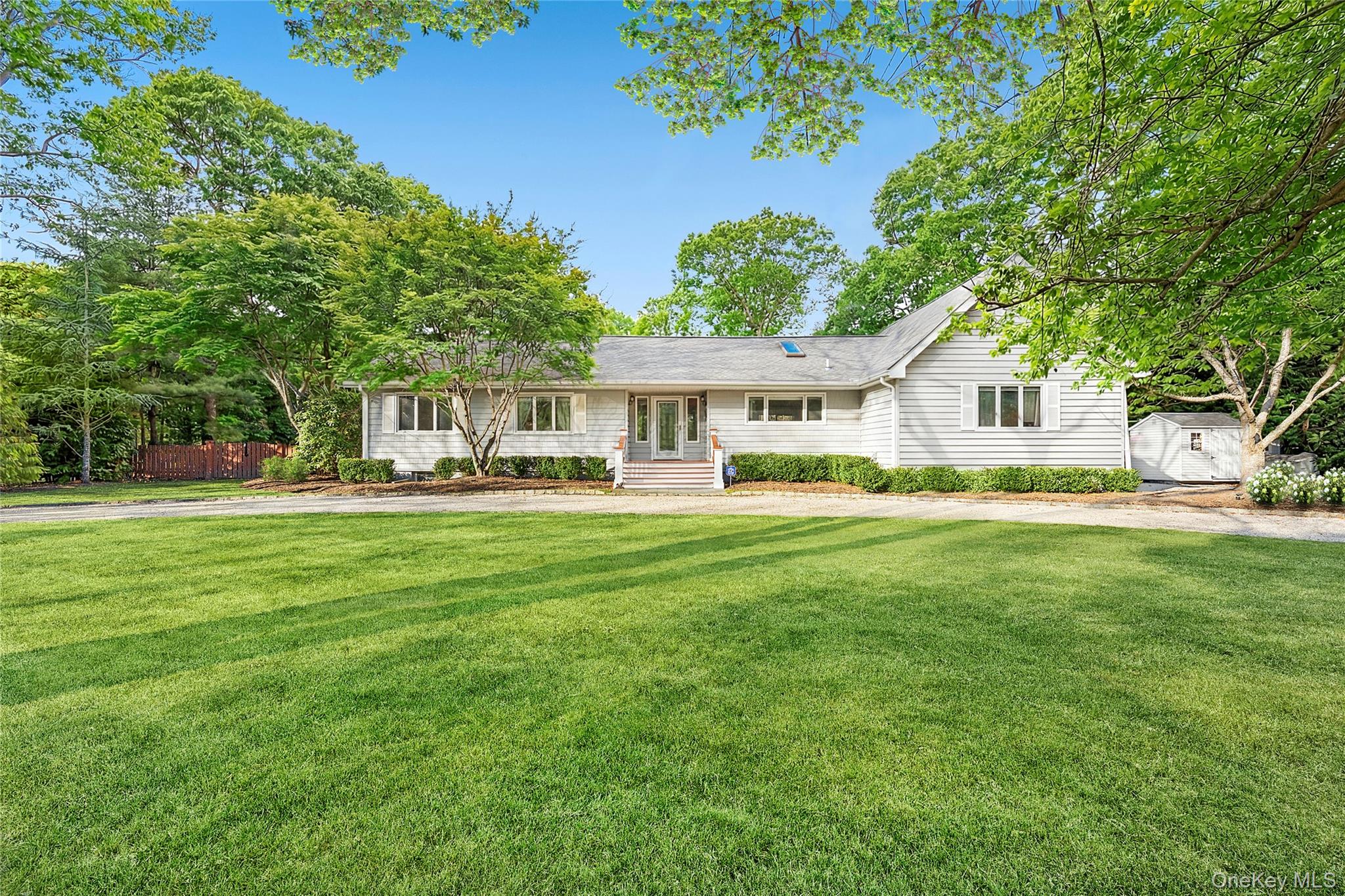47 Bridle Path Remsenburg, NY 11960 - Photo 2 of 20 a front view of a house with a yard