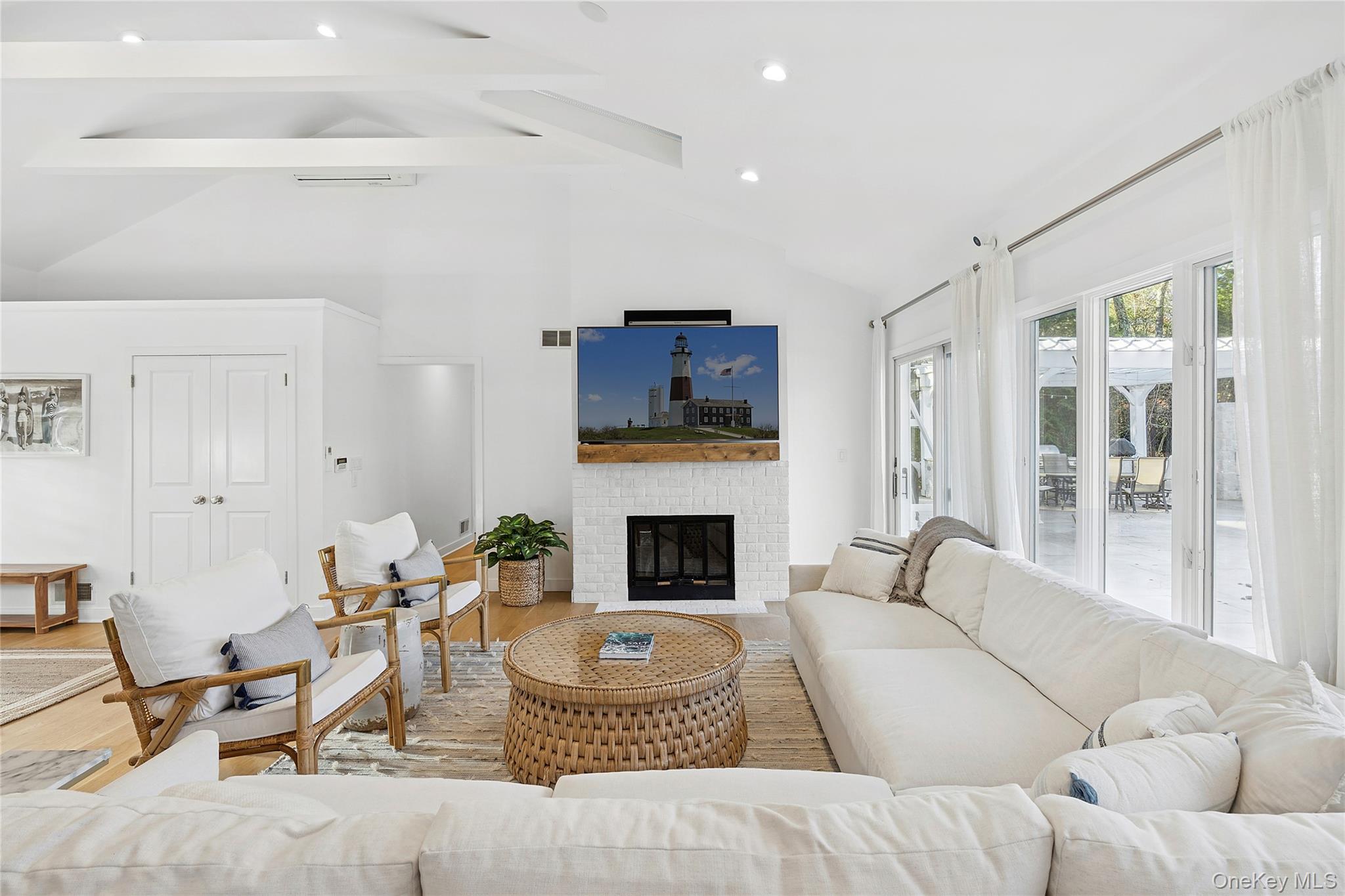 47 Bridle Path Remsenburg, NY 11960 - Photo 4 of 20 a living room with furniture fireplace and a flat screen tv