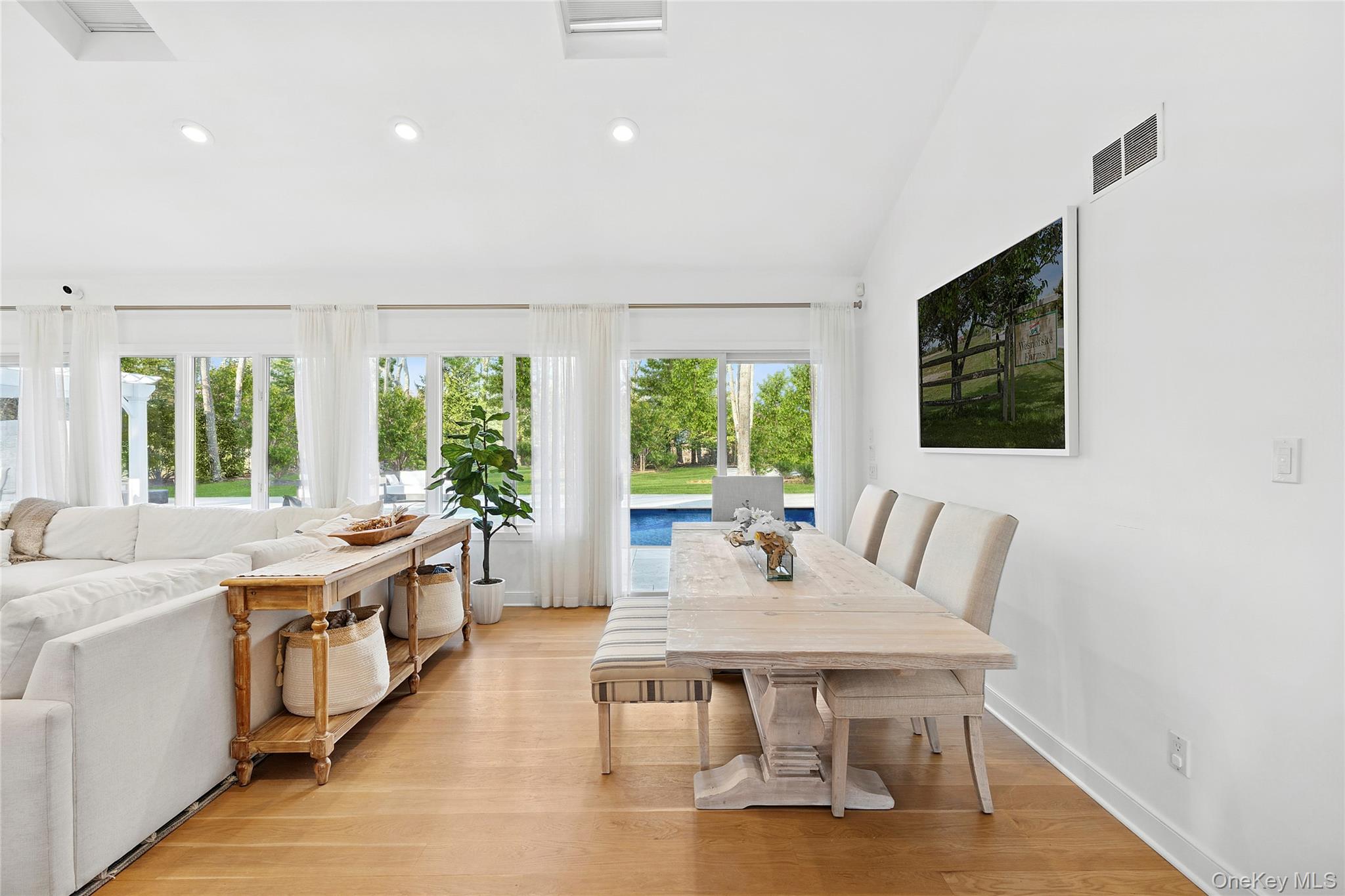 47 Bridle Path Remsenburg, NY 11960 - Photo 5 of 20 a dining room with a table chairs and a kitchen view