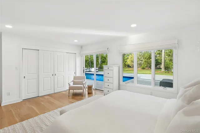 a spacious bedroom with a large bed and a large window