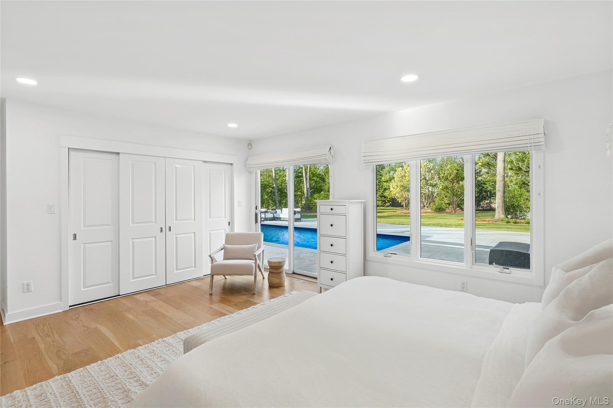 47 Bridle Path Remsenburg, NY 11960 - Photo 8 of 20 a spacious bedroom with a large bed and a large window