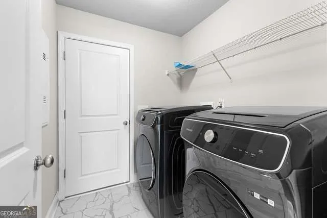 a utility room with dryer and washer