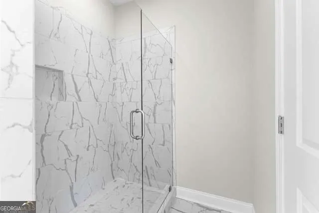 a bathroom with a granite countertop double vanity sink and a mirror