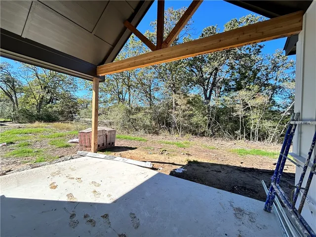 a view of a backyard with floor to ceiling window and a yard
