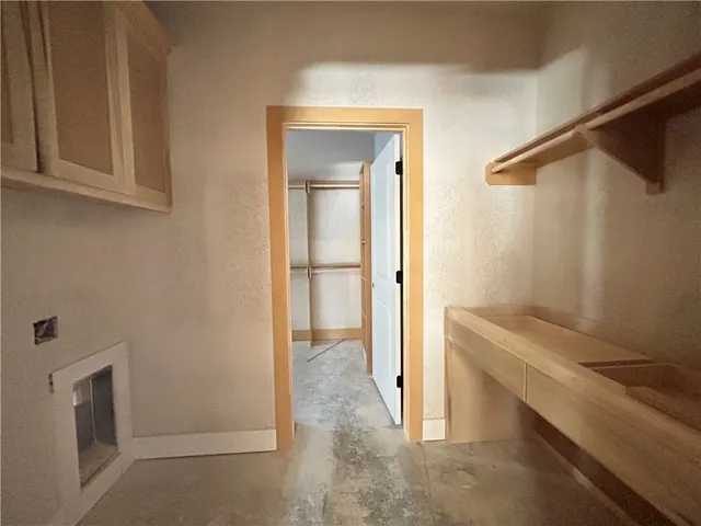 a view of storage and utility room with closet