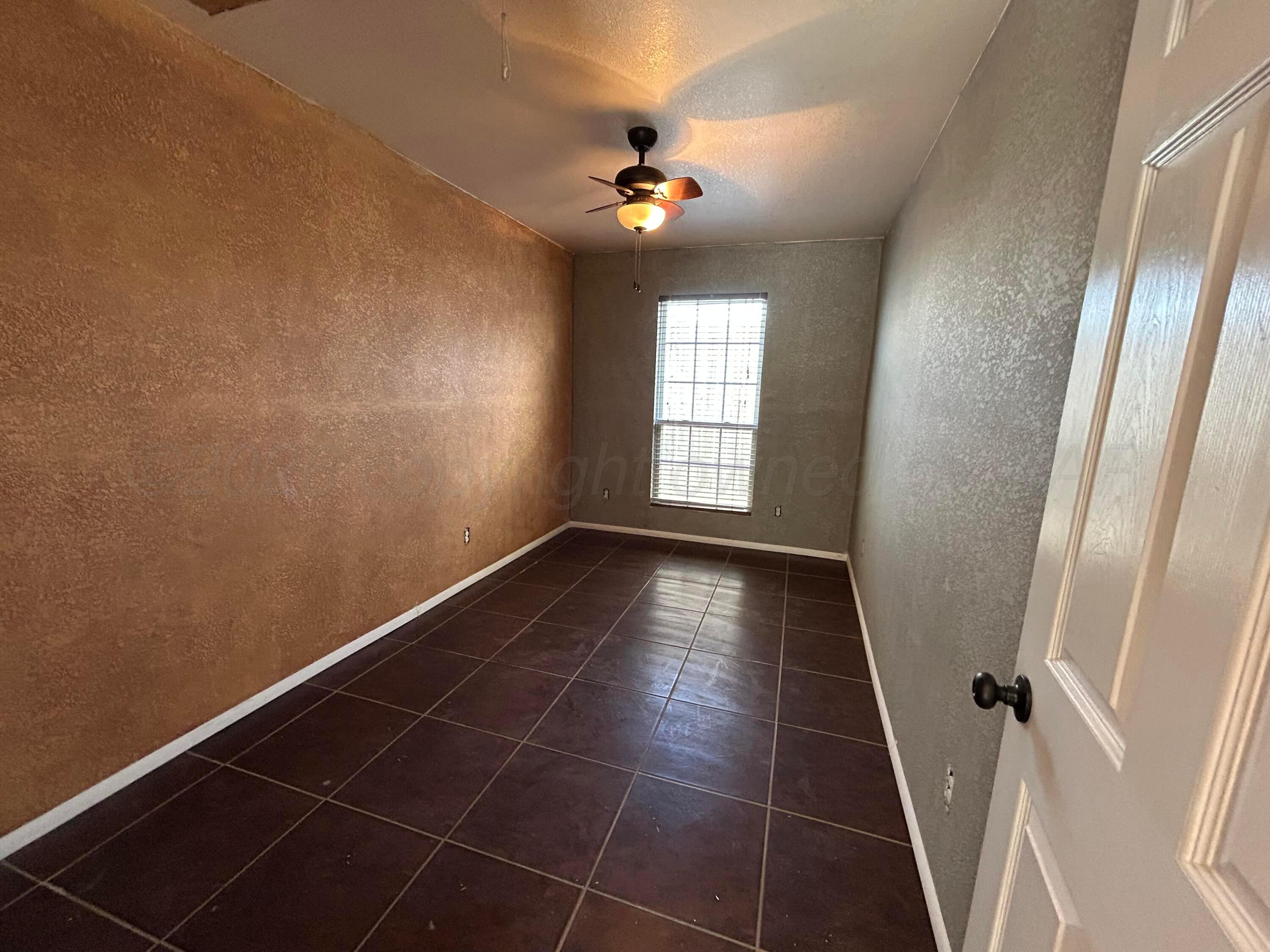 923 Elmore Street Borger, TX 79007 - Photo 13 of 18 a view of an empty room with a window