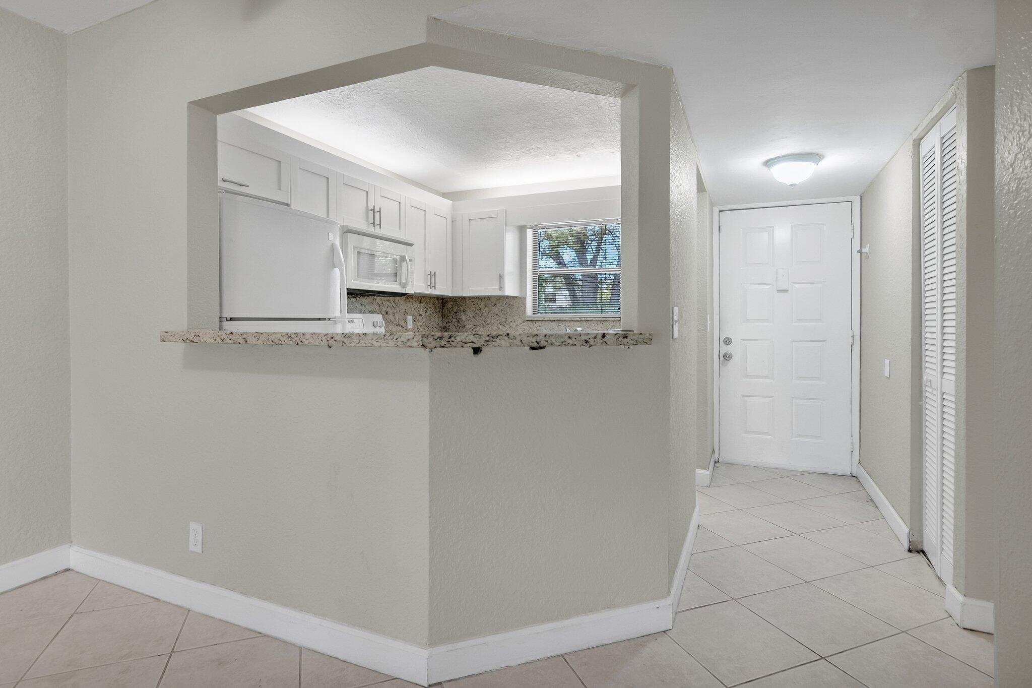 21911 Lake Forest Circle, Unit 103 Boca Raton, FL 33433 - Photo 9 of 24 Dining onto kitchen