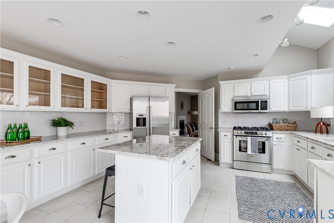 3207 Stony Point Road, Unit C Richmond, VA 23235 - Photo 20 of 40 a kitchen with granite countertop a center island stainless steel appliances and cabinets