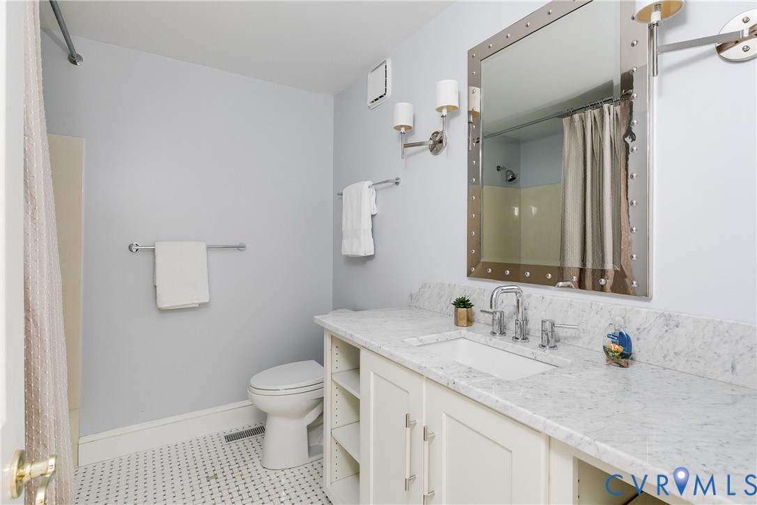 3207 Stony Point Road, Unit C Richmond, VA 23235 - Photo 24 of 40 a bathroom with a granite countertop sink a toilet and a mirror