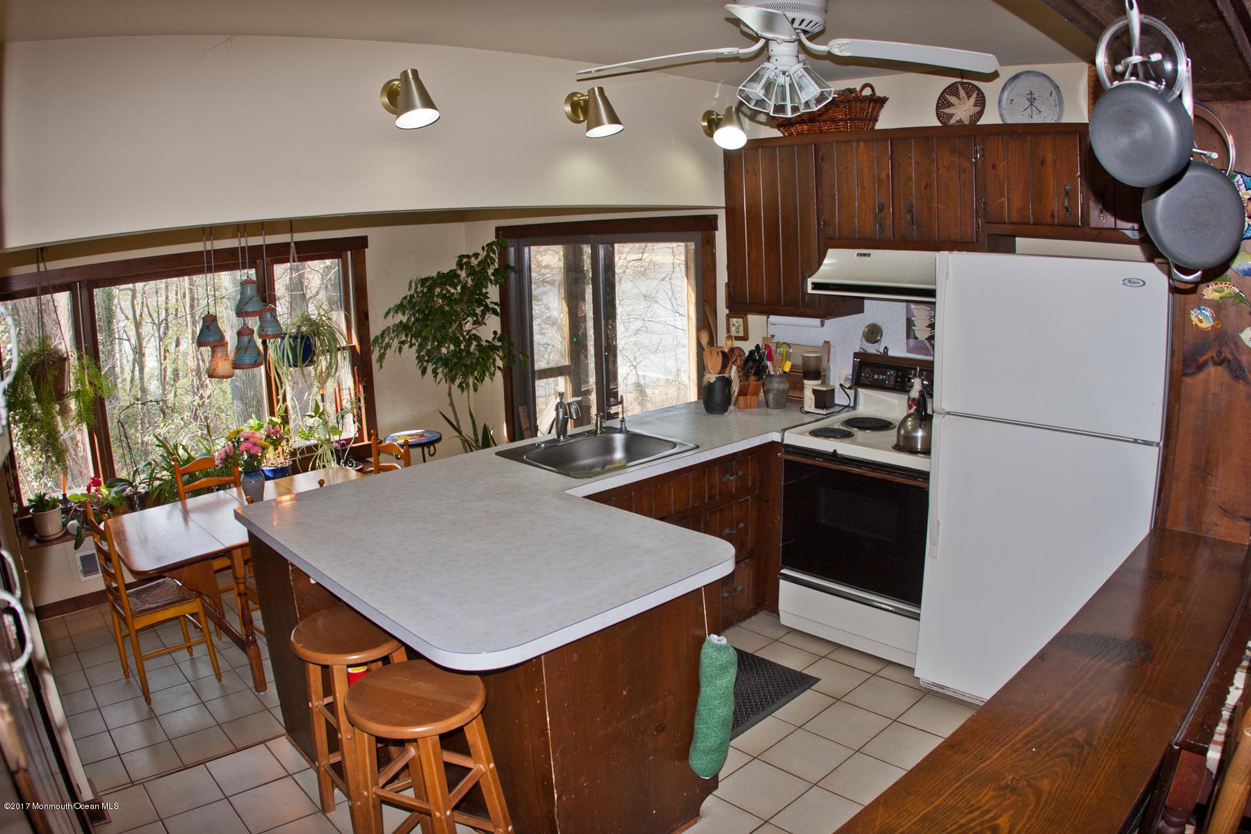 626 South Riverside Drive Neptune Township, NJ 07753 - Photo 12 of 32 a kitchen with sink cabinets and window