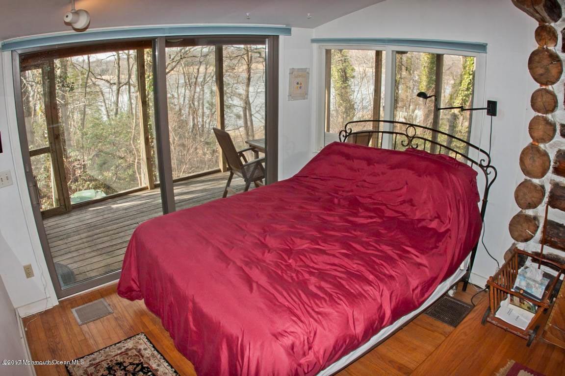 626 South Riverside Drive Neptune Township, NJ 07753 - Photo 15 of 32 a bed sitting in a bedroom next to a window