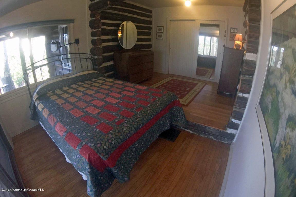 626 South Riverside Drive Neptune Township, NJ 07753 - Photo 16 of 32 a bed sitting in a room next to a window