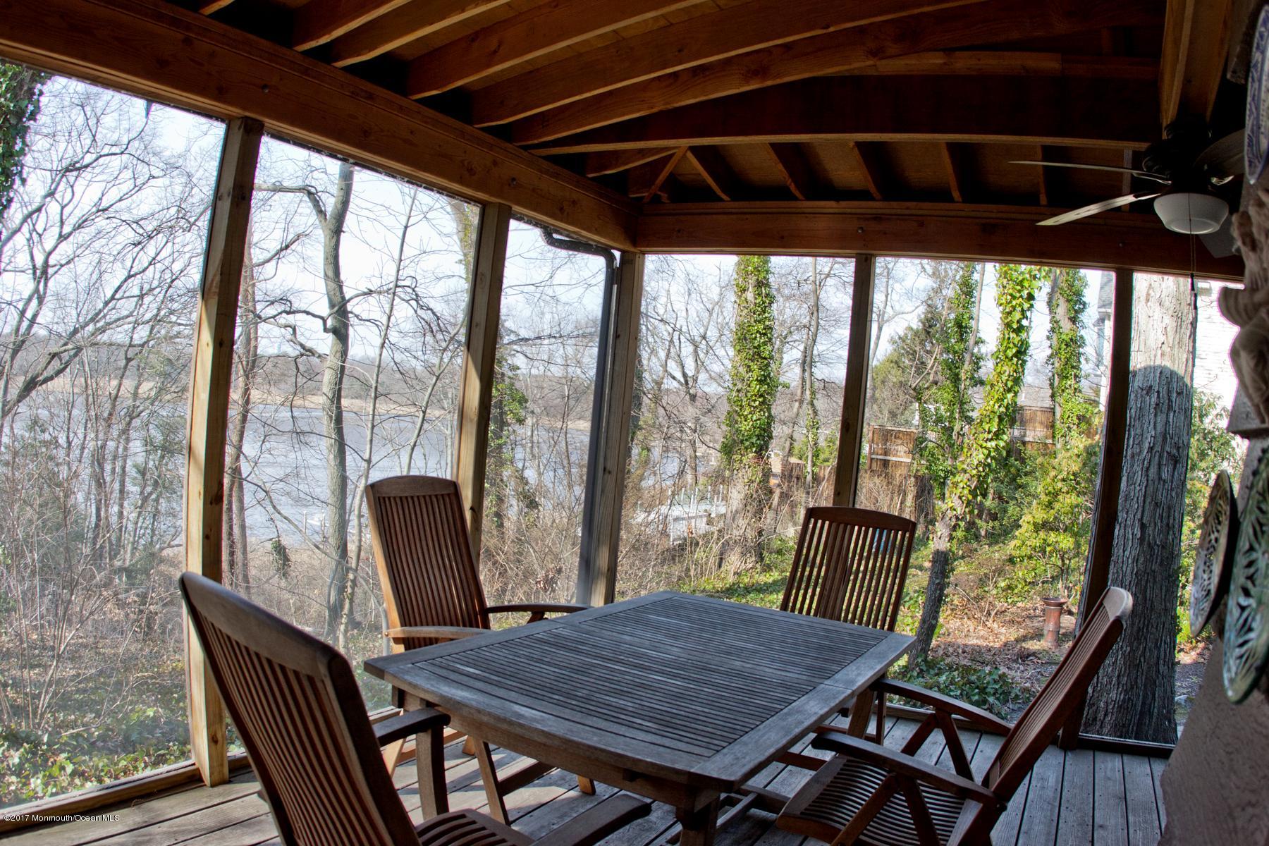 626 South Riverside Drive Neptune Township, NJ 07753 - Photo 19 of 32 a view of a porch with furniture and wooden floor