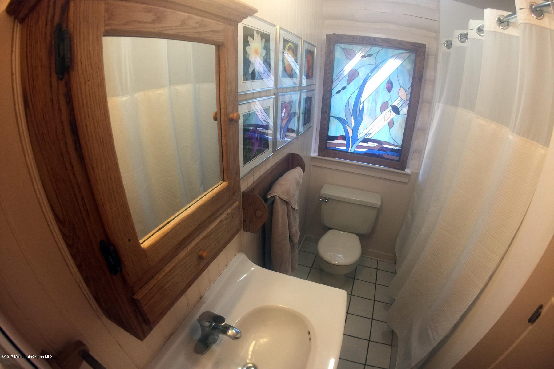 626 South Riverside Drive Neptune Township, NJ 07753 - Photo 20 of 32 a bathroom with a sink and a mirror