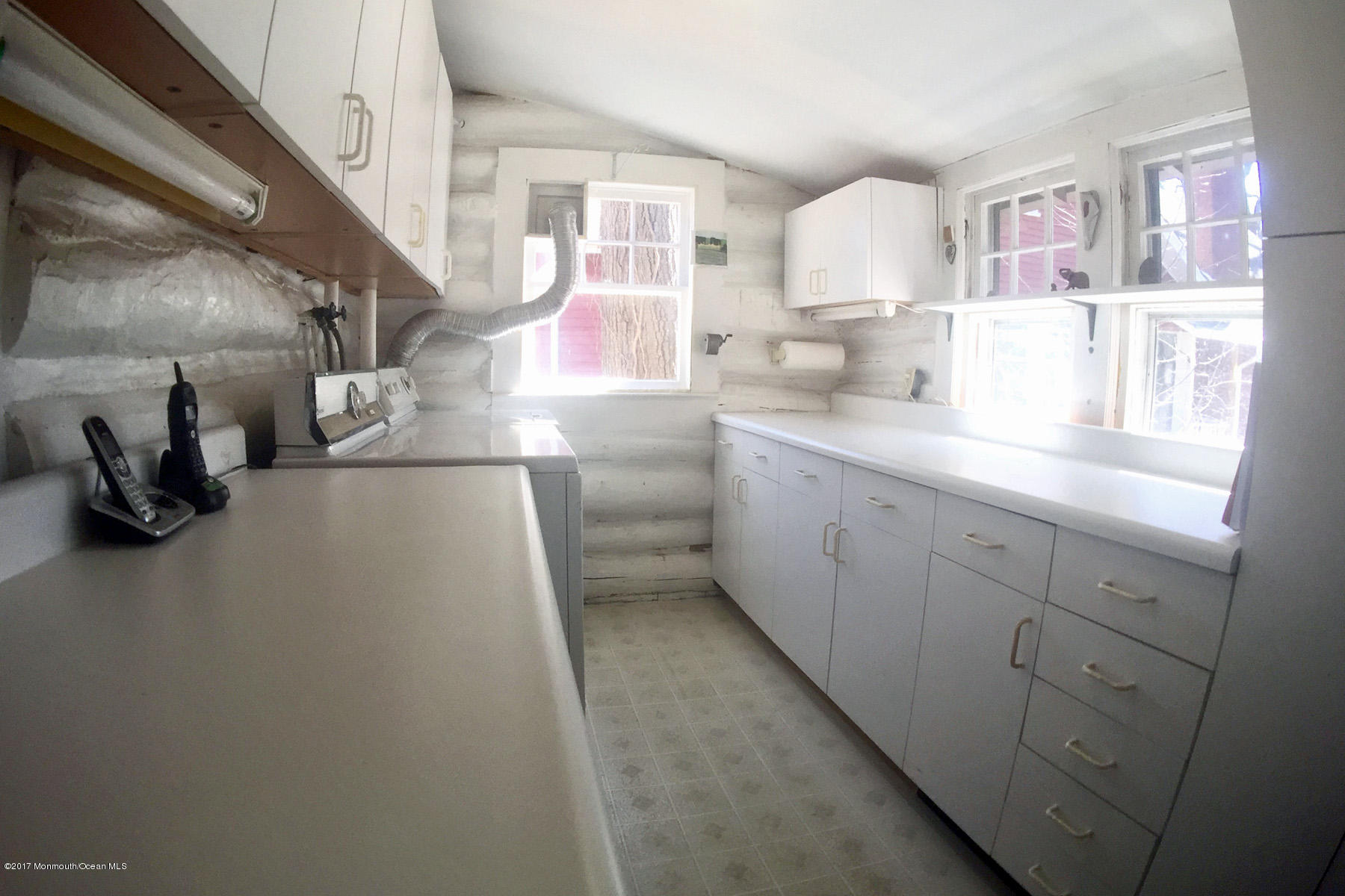 626 South Riverside Drive Neptune Township, NJ 07753 - Photo 21 of 32 a kitchen with cabinets a sink and a stove next to a window