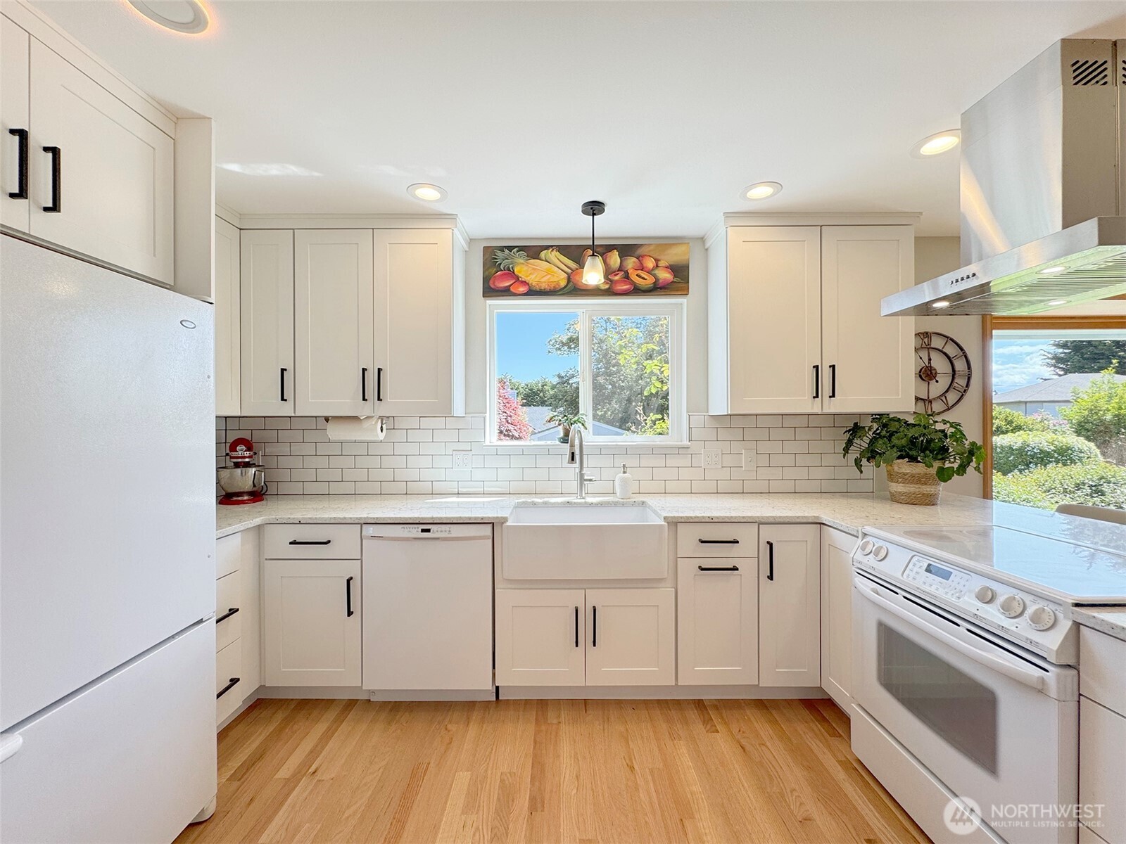 22 East Bedinger Road Sequim, WA 98382 - Photo 13 of 40 a kitchen with a sink cabinets wooden floor and stainless steel appliances