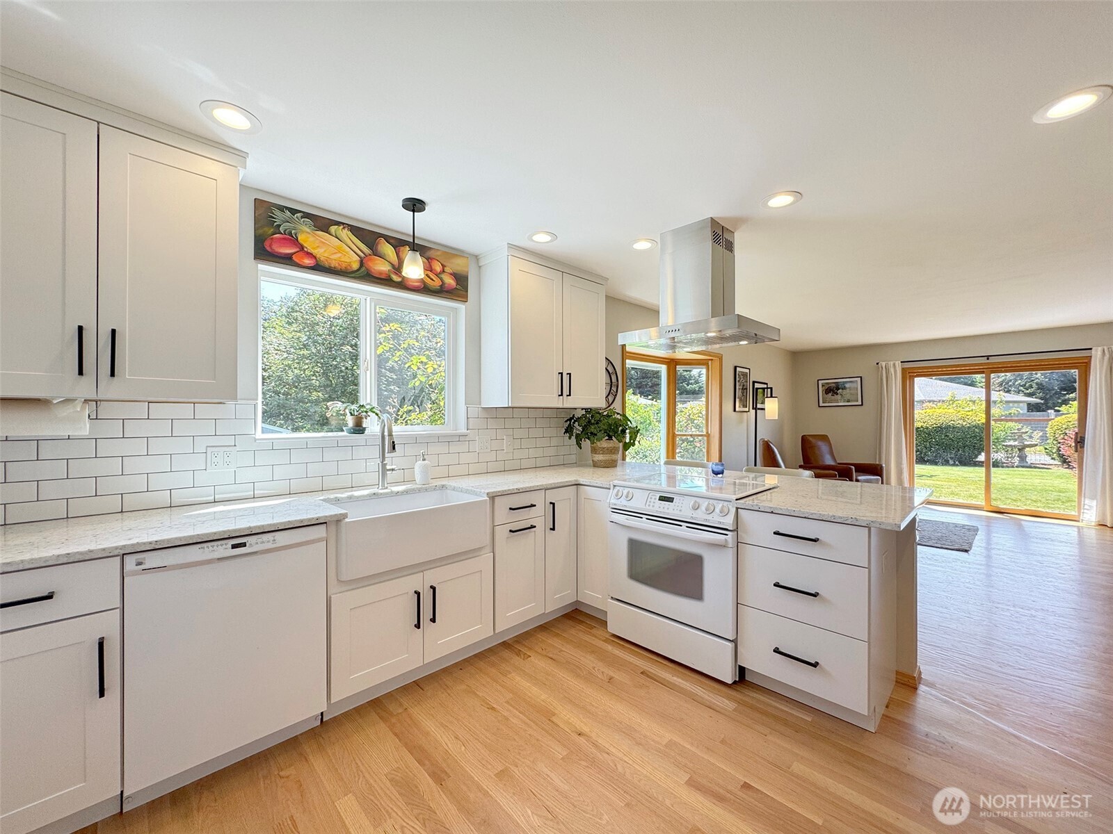 22 East Bedinger Road Sequim, WA 98382 - Photo 14 of 40 a kitchen with white cabinets and wooden floors