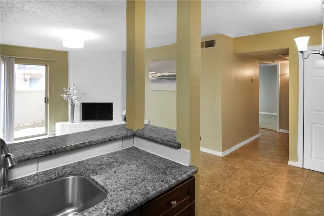 a kitchen with a sink and a refrigerator