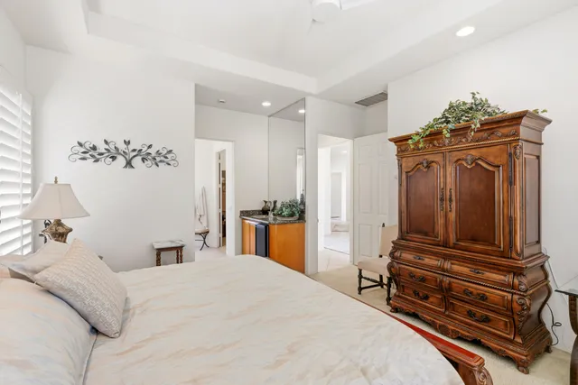 a bedroom with a bed and a dresser