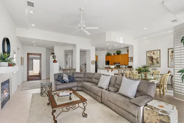 a living room with furniture and a chandelier