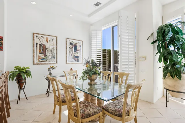 a view of a dining room with furniture and window