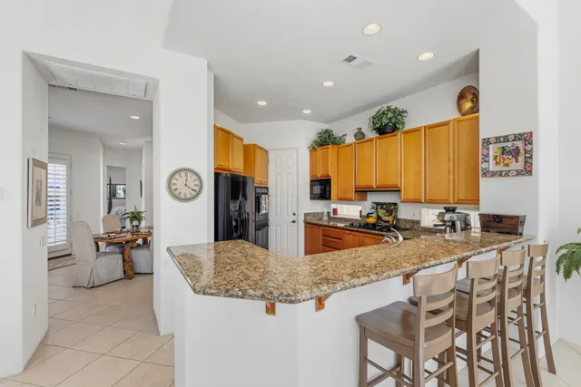 a kitchen with sink and chairs