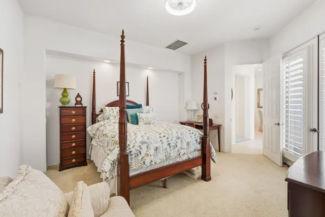 a bedroom with a bed window and a table