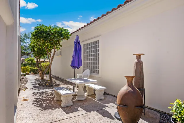 a view of a house with sitting area and garden