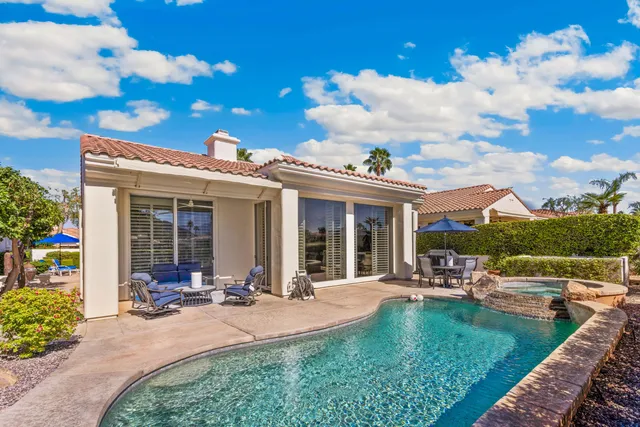 a view of a house with swimming pool and porch