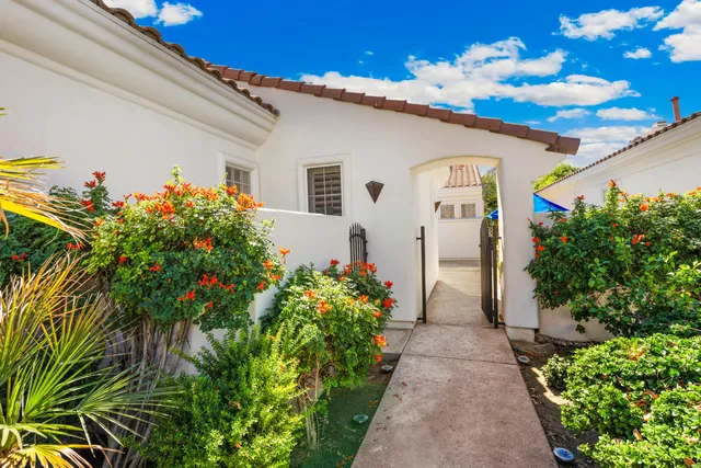 a front view of a house with plants