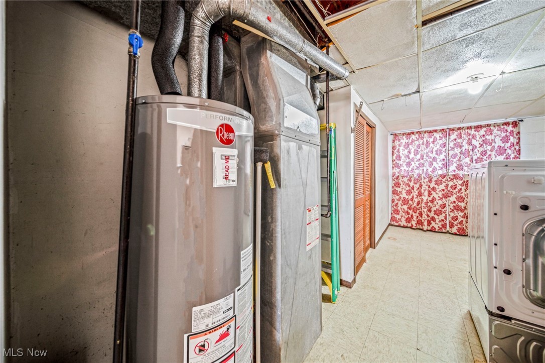 1861 Sterling Road Madison, OH 44057 - Photo 33 of 37 Utility room with water heater and washer / dryer and oven