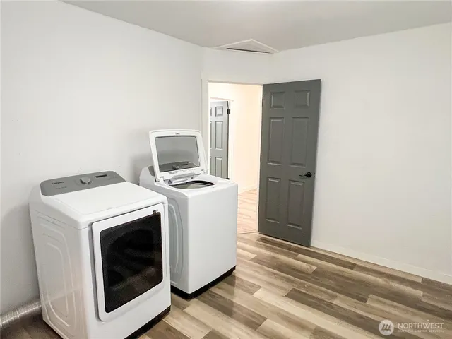 an empty room with wooden floor and closet