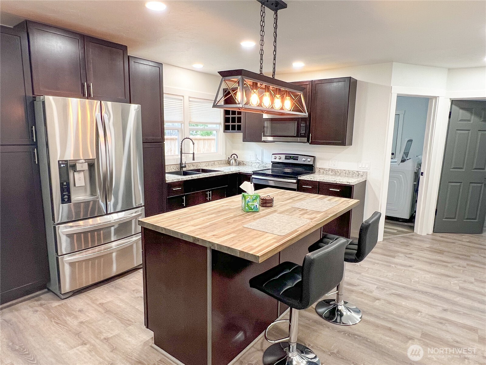 6192 State Rte 20 Port Townsend, WA 98368 - Photo 9 of 25 a kitchen with kitchen island a wooden floor and refrigerator